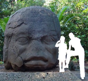 Gigantic Olmec head in Mexico, reminding of the first millenniun BC. The author of the photograph uploaded in 2008 to Vikiteka was indicated as Simon Burchell. Anonymous woman and girl's figures allows a better understanding of the size proportions. Like other surviving Olmec heads this one also has negroid facial features.