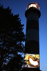 A. Maknytė's artistic act near Nida lighthouse during the photo artists' seminar.